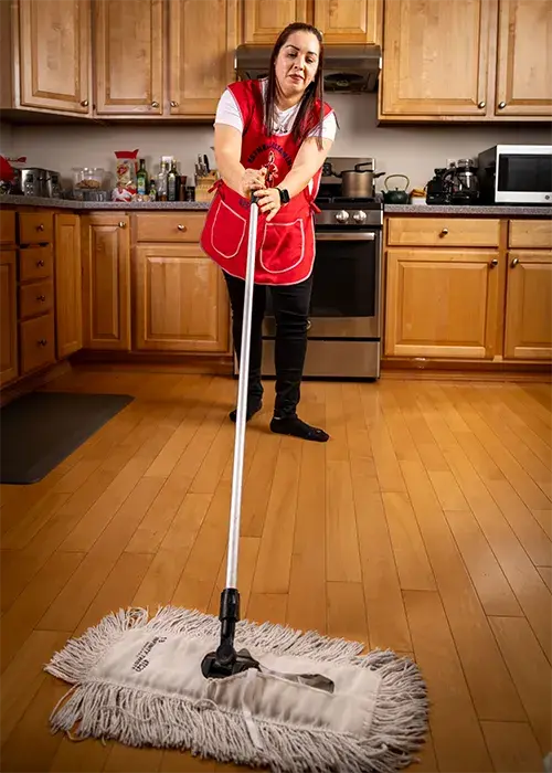 A photo of an Esthela cleaner mopping a floor until it shines